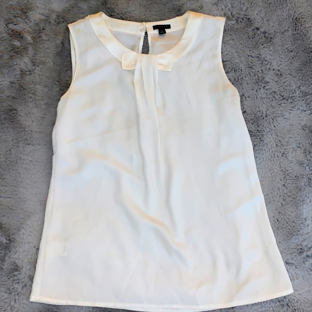 White silky tank with a bow design in middle